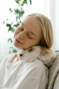 Image of a girl cuddling with a rabbit